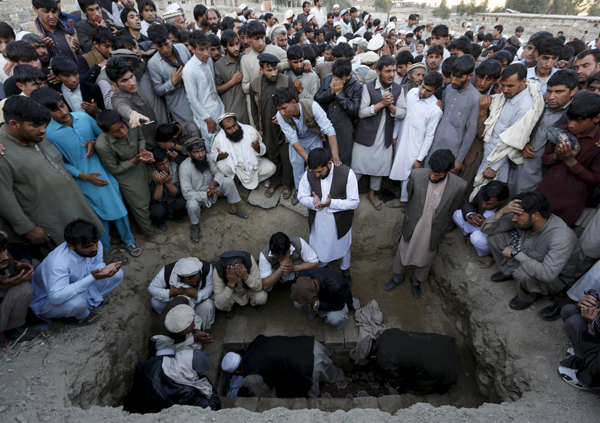 Relatives and residents take part in a funeral ceremony for one of the victims of a suicide attack in Asadabad, capital of Kunar province, Afghanistan, on Saturday (Reuters photo)