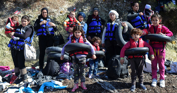 Syrian migrants wear life jackets and life belts before boarding a dinghy to cross the Aegean Sea to the Greek island of Lesbos from the Ayvacik coast in Canakkale, Turkey, on Sunday (AFP photo)