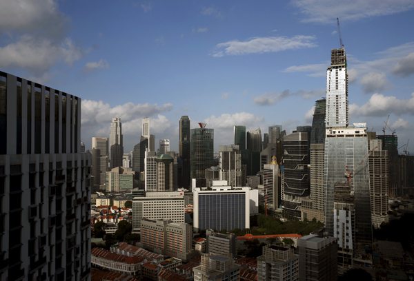 GuocoLand Ltd.'s mixed-use Tanjong Pagar Centre (right), soon to be the tallest building in the city-state, towers over other buildings in the central business district of Singapore on Monday (Reuters photo)