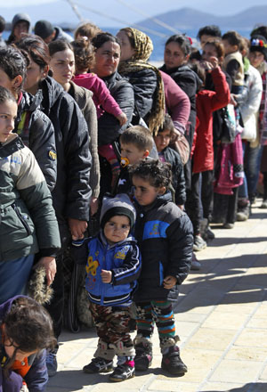 Migrants wait in line on the eastern Greek island of Samos after they were rescued while trying to cross Aegean Sea in a dinghy between the eastern Greek Island of Agathonisi and the nearby Turkish shores, on Thursday (AP photo)
