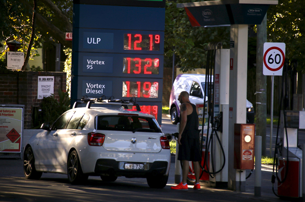 A customer fills his car with petrol at a gas station, where unleaded petrol is priced at A$1.219 ($0.86) per litre, in Sydney, Australia, February 8 (Reuters photo)