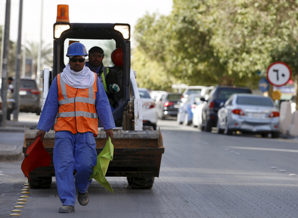 A labourer walks as he works outside a residential building in Riyadh, Saudi Arabia, on February 9 (Reuters photo)