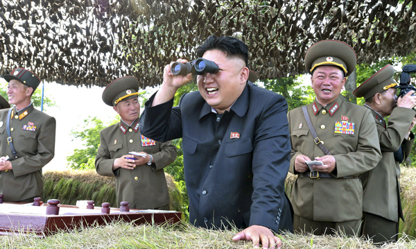 North Korean leader Kim Jong-un looks through a pair of binoculars during an inspection of the Hwa Islet Defence Detachment standing guard over a forward post off the east coast of the Korean peninsula, in this undated file photo released by North Korea’s Korean Central News Agency in Pyongyang, on July 1, 2014 (Reuters photo/KCNA)