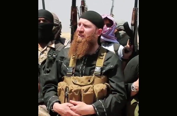 This image made from undated video posted during the weekend of June 28, 2014 on a social media account frequently used for communications by the Daesh terror group, which has been verified and is consistent with other AP reporting, shows Omar Al Shishani standing next to the group's spokesman among a group of militants, as they declare the elimination of the border between Iraq and Syria (AP photo)