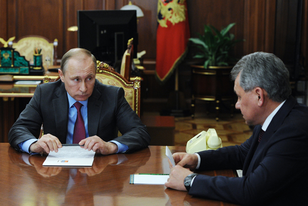Russian President Vladimir Putin listens to Russian Defence Minister Sergey Shoygu (right) during their meeting in the Kremlin in Moscow, Russia, on Monday (AP photo)