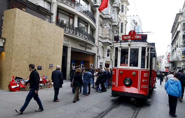 A vintage tram moves past the scene of suicide bombing at Istiklal street, a major shopping and tourist district, in central Istanbul, Turkey, on March 22 (Reuters photo)