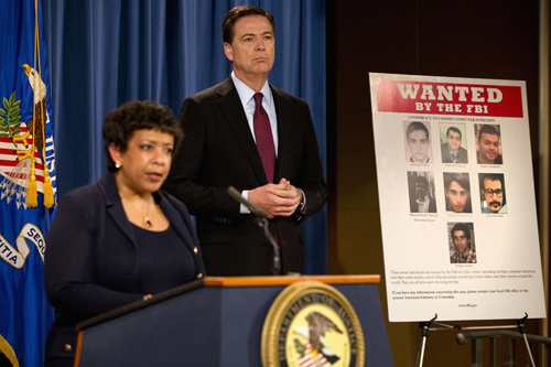 Attorney General Loretta Lynch and FBI Director James Comey stand by a wanted poster of Iranians who are wanted by the FBI for computer hacking during a news conference at the Justice Department in Washington on Thursday (AP photo)