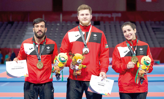 Jordan’s national Ju-jitsu team members display medals they won in the Asian Games competitions in Jakarta on Saturday. Freeh Harahshey (left) displays his bronze in the under-62kg category, Zaid Sami displays his silver gained in the under-94kg category (centre) and Yara Qaqish holds her bronze in the under 62kg category (Photo courtesy of Jordan Olympic Committee)