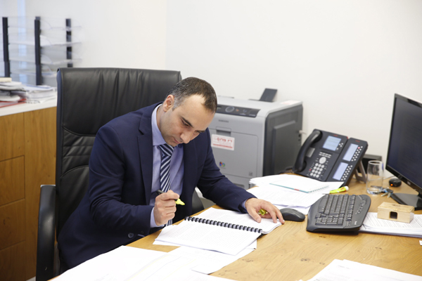 Yossi Abu, chief executive of Delek's subsidiaries Delek Drilling and Avner Oil, reads the ruling of Israel's supreme court decision to temporarily block a landmark natural gas agreement, announced late on Sunday (Reuters photo)