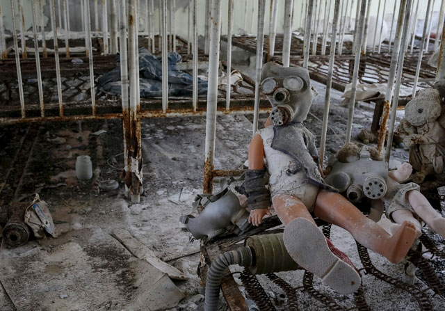 A doll with a children’s gas mask is seen amongst beds at a kindergarten in the abandoned city of Pripyat near the Chernobyl nuclear power plant in Ukraine on Monday (Reuters photo)