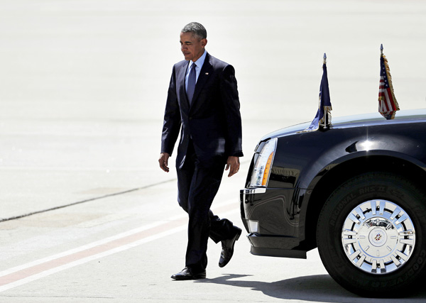 President Barack Obama walks over to shake hands with guests on the tarmac after arriving on Air Force One at Hartsfield-Jackson Atlanta International Airport on Tuesday (AP photo)