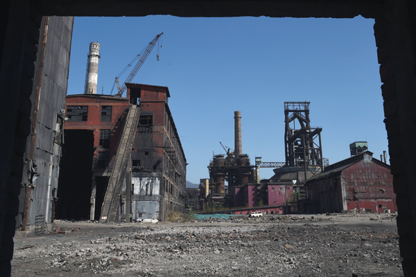 In this photo taken on April 7,  partly demolished buildings are seen at the closed Shougang Capital Iron and Steel plant in Beijing. The plant closed in 2011 (AFP photo)