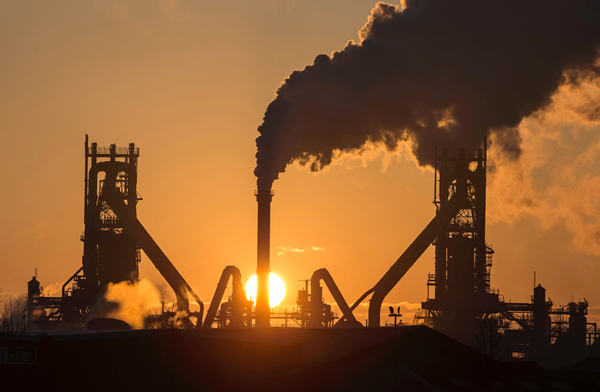 This file photo taken on March 31 shows the sun rising above Tata Steel’s blast furnaces at their Scunthorpe Plant in north east England (AFP photo)