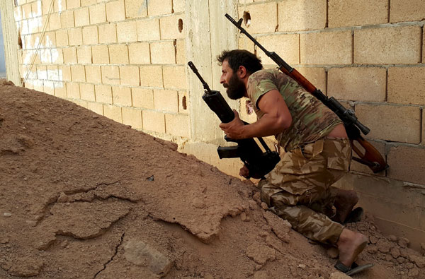 A member of forces loyal to Libya's eastern government carries his weapon during clashes with the Shura Council of Libyan Revolutionaries in Benghazi, Libya, on Tuesday (Reuters photo)