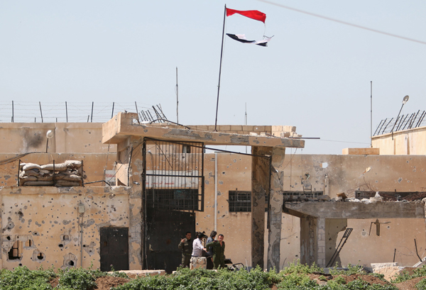 Government forces surrender themselves to Kurdish fighters in the city of Qamishli, Syria, on Thursday (Reuters photo)