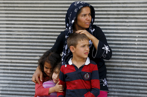 A mother and her children react after two rockets hit the Turkish town of Kilis, near the Syrian border, Turkey, Sunday (Reuters photo)
