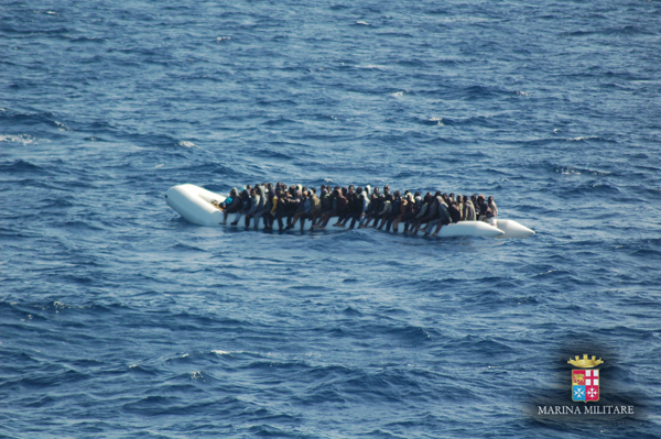 This handout file photo released by the Italian Navy (Marina Militare) on March 16, 2016, shows migrants and refugees seated on an inflatable boat during a rescue operation off the coast of Sicily (AFP photo/Guardia Costiera)