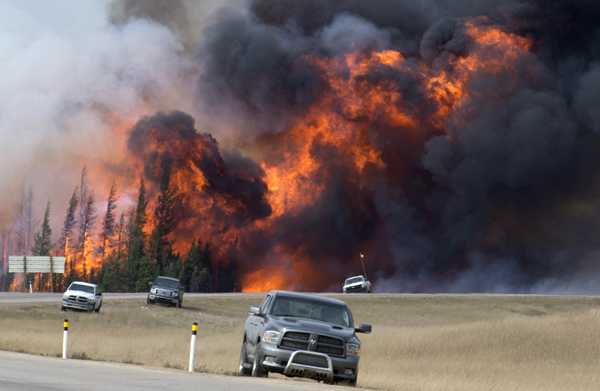 A wildfire burns south of Fort McMurray, Alberta, near Highway 63 on Saturday (Jonathan Hayward /The Canadian Press via AP)