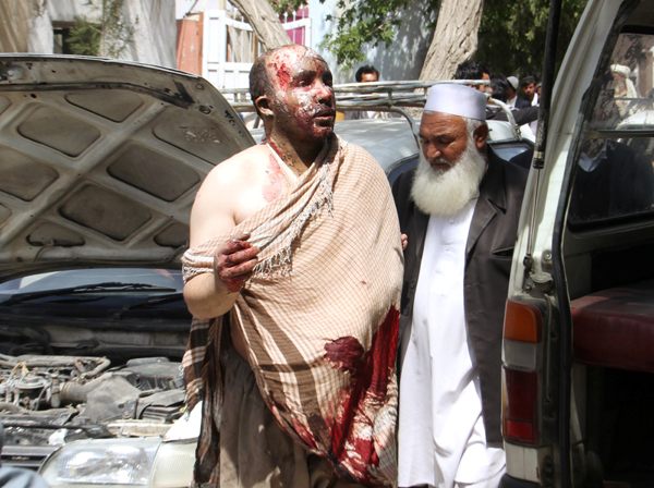 An injured man arrives to a hospital after two buses collided with a fuel tanker on a highway in the central province of Ghazni, Afghanistan, on Sunday (Reuters photo)