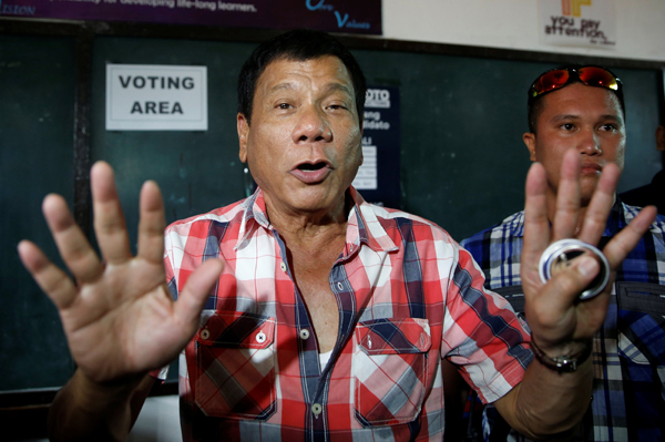 Residential candidate Rodrigo Duterte talks to the media before casting his vote at a polling precinct for national elections at Daniel Aguinaldo National High School in Davao city in southern Philippines, on Monday (Reuters photo)