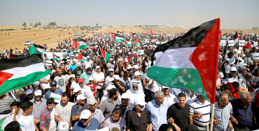 Arab Israelis and other supporters wave Palestinian flags as they march during a protest to mark the right of return for refugees who fled their homes during the 1948 Arab-Israeli war, at a village near Rahat in southern Israel, on Thursday. The 1948 war followed the creation of Israel on Palestinian land (Reuters photo by Ammar Awad)