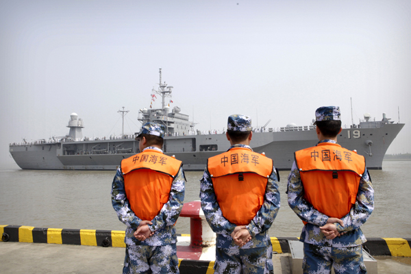 In this May 6 file photo, soldiers from the Chinese People's Liberation Army’s navy watch as the USS Blue Ridge arrives at a port in Shanghai (AP photo)