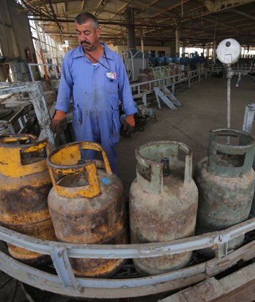 Iraqi workers are seen at the Taji gas plant, 20km  north of Baghdad, on Wednesday (AFP photo)