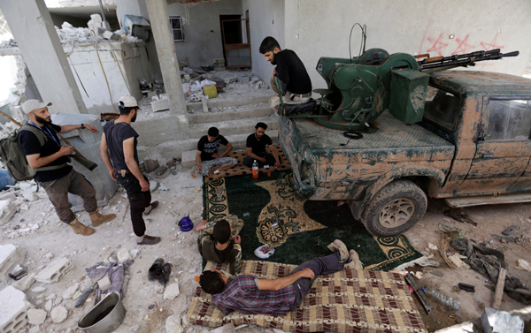  Rebel fighters from Jaysh Al Sunna, operating under a coalition of rebel groups called Jaish Al Fatah, or the army of conquest, rest in Aziziyah village, southern Aleppo countryside, Syria, last week (Reuters photo)