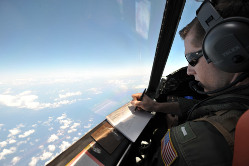 US navy LT JG Curtis Calabrese takes notes on board of a US navy Lockheed P-3C Orion patrol aircraft from Sigonella, Sicily, on Sunday (AP photo)