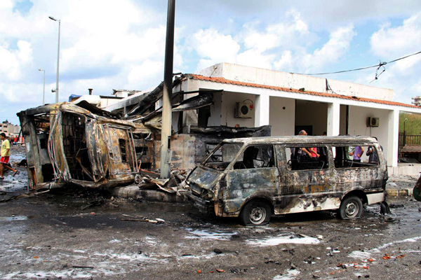 In this photo released by the Syrian official news agency SANA, the wreckage of burned vehicles is seen at the site of a bombing, in the coastal towns of Tartus, Syria, on Monday (AP photo)