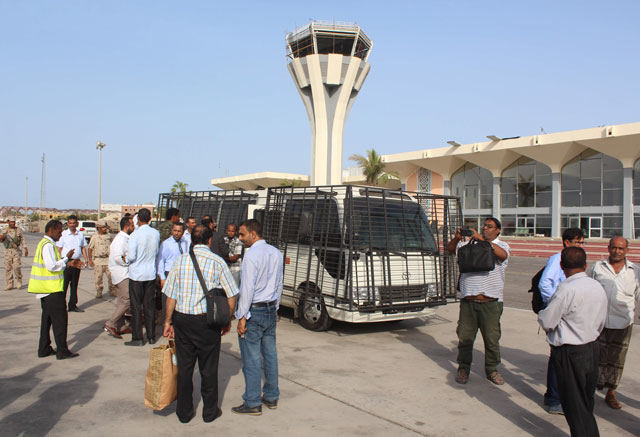  People stand outside the International Airport of the southern port city of Aden, on Monday (AFP photo)