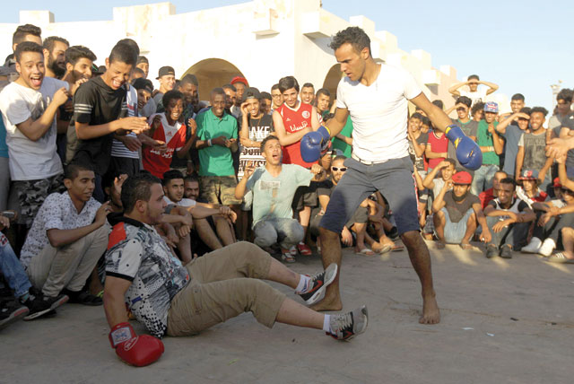  A Libyan man knocks out his counterpart in a boxing match in a street in the coastal city of Benghazi on Friday (AFP photo)