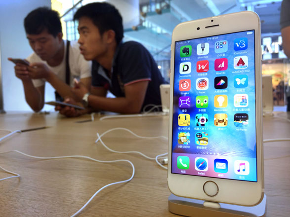 Customers look at Apple iPhone 6S models on display at an Apple Store in Beijing on Saturday (AP photo)