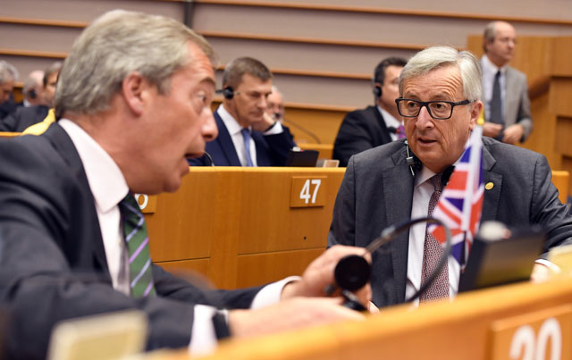 European Commission President Jean-Claude Juncker (right) speaks with UKIP leader Nigel Farage during a special session of European Parliament in Brussels on Tuesday (AP photo)