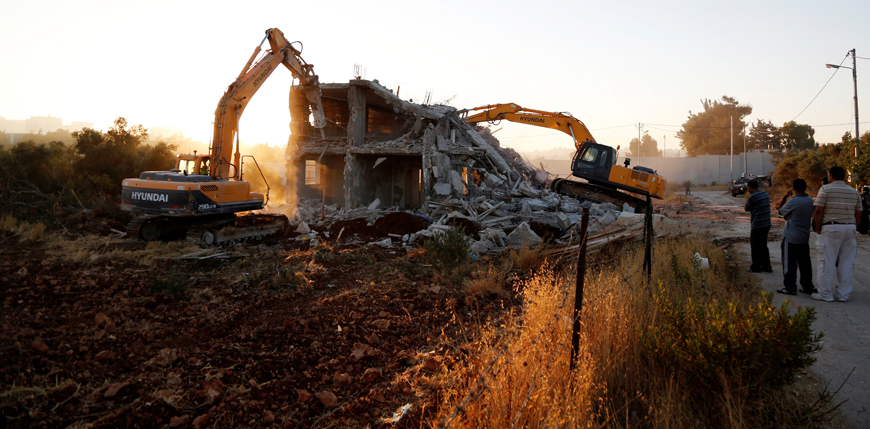 Israeli machinery demolish a Palestinian house in the West Bank village of Qalandia near Ramallah on Tuesday (Reuters photo)