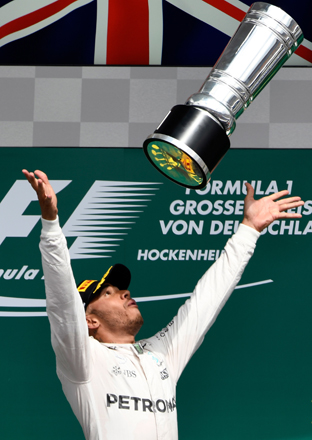 Mercedes driver Lewis Hamilton of Britain throws his trophy in the air after winning the German Formula One Grand Prix in Hockenheim, Germany, on Sunday (AP photo)
