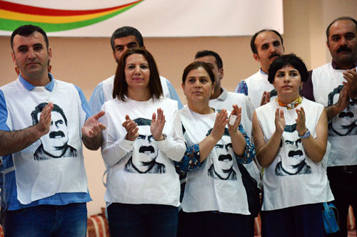 People wearing T-shirts featuring jailed PKK leader Abdullah Ocalan applaud after Turkey’s pro-Kurdish People’s Democratic Party co-chair Sebahat Tuncel speech on Monday in Diyarbakir before starting a hunger strike to demand news about the Kurish leader. Several pro-Kurdish parties and activist groups say they have no news about jailed PKK leader Abdullah Ocalan for more than 500 days and they will continue the strike until they get some news (AFP photo)