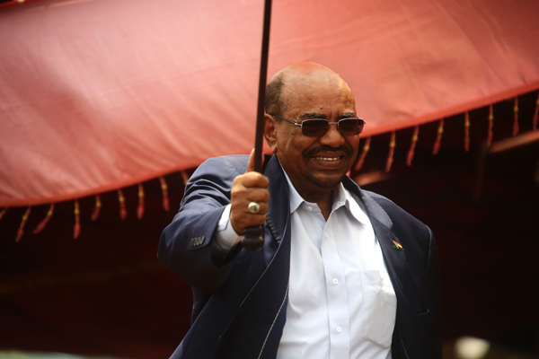 Sudanese President Omar Al Bashir waves on stage during a ceremony to declare an end to 13 years of conflict in Darfur on Wednesday in the North Darfur state capital El Fasher (AFP photo)