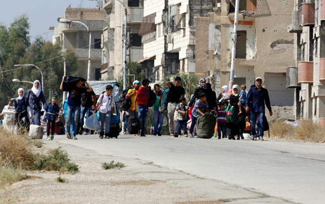 In this September 2 photo, Syrians leave the Moadamiyeh suburb of Damascus, Syria (AP photo)