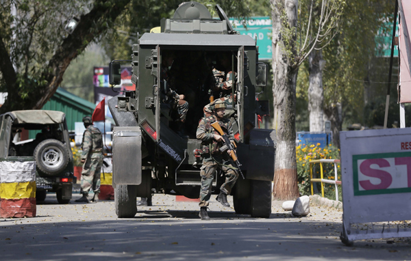 Indian army soldiers arrive at the army base which was attacked by suspected rebels in the town of Uri, west of Srinagar, Indian controlled Kashmir, on Sunday (AP photo)