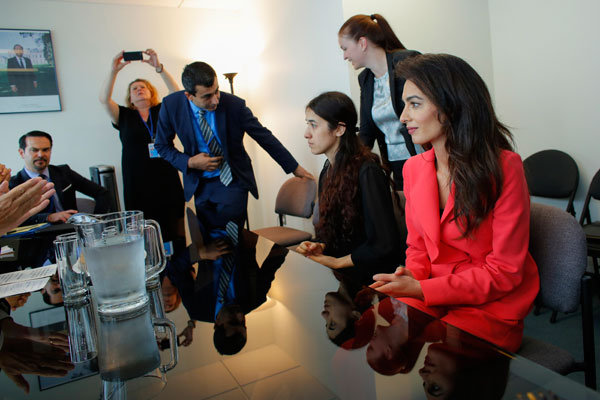 Nadia Murad (2nd right), UNODC goodwill ambassador and human rights lawyer, Amal Clooney (right) attend a meeting with French Foreign Affairs Minister Jean-Marc Ayrault at the United Nations headquarters in New York on Monday (AFP photo)