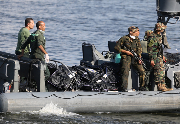 The bodies of victims of a boat carrying migrants that capsized off Egypt’s coast are seen on a military boat in Al Beheira, Egypt, on Thursday (Reuters photo)