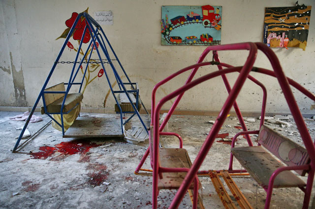 Blood stains the ground under swings in a damaged kindergarten after an air strike in the rebel-held besieged city of Harasta, in the eastern Damascus suburb of Ghouta, Syria, on Sunday (Reuters photo)