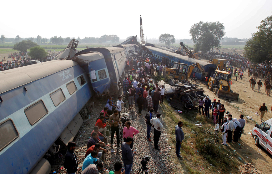Rescue workers search for survivors at the site of a train derailment in Pukhrayan, south of Kanpur city, India, on Sunday (Reuters photo)