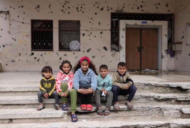 Palestinian orphans pose for a picture at the war-damaged Al Amal orphanage in Gaza City on March 6, 2025 (AFP photo)