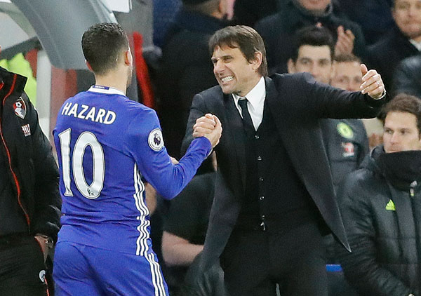 Chelsea’s Eden Hazard and Chelsea’s team manager Antonio Conte celebrate after winning the English Premier League football match between Chelsea and Bournemouth at Stamford Bridge Stadium in London on Monday (AP photo by Frank Augstein)