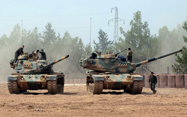 Turkish army tanks are stationed near the Syrian border in Karkamis, Turkey, Thursday (AP photo)