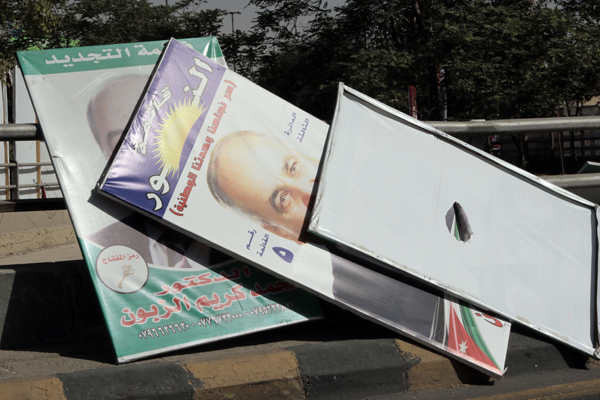 Electoral campaign posters are seen after being cleared from a street in Amman on Wednesday (Photo by Osama Aqarbeh)