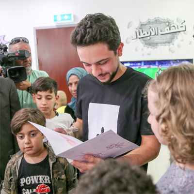 HRH Crown Prince Hussein interacts with children at the newly inaugurated ‘Heroes Cave’ child waiting area at the King Hussein Cancer Centre on Wednesday  (Photo courtesy of Royal Court)