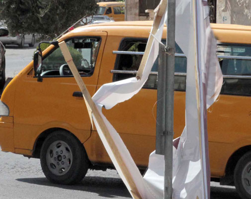 A torn electoral campaign poster is seen in Amman late last week (Photo by Hassan Tamimi)